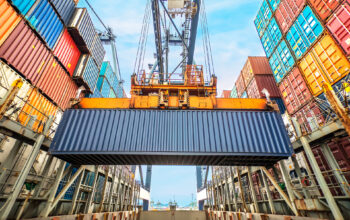 Container loading in a Cargo freight ship with industrial crane. Container ship in import and export business logistic company. Industry and Transportation concept.