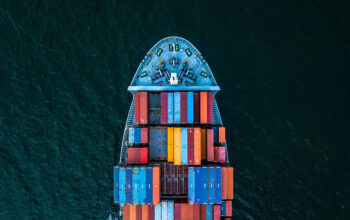 Container ship carrying container for import and export, business logistic and transportation by container cargo ship in open sea, Aerial view container ship vessel.