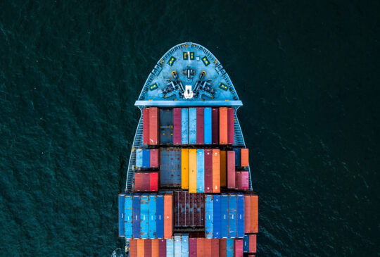 Container ship carrying container for import and export, business logistic and transportation by container cargo ship in open sea, Aerial view container ship vessel.